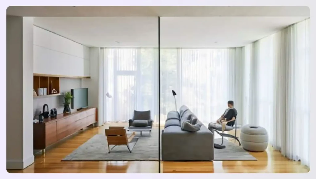 A sleek, partial glass divider in a modern living room