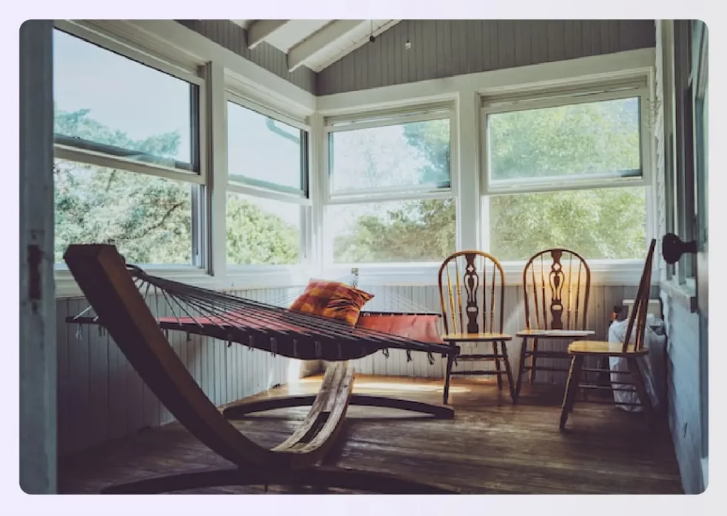 An enclosed back patio with a hammock An enclosed back patio with a hammock