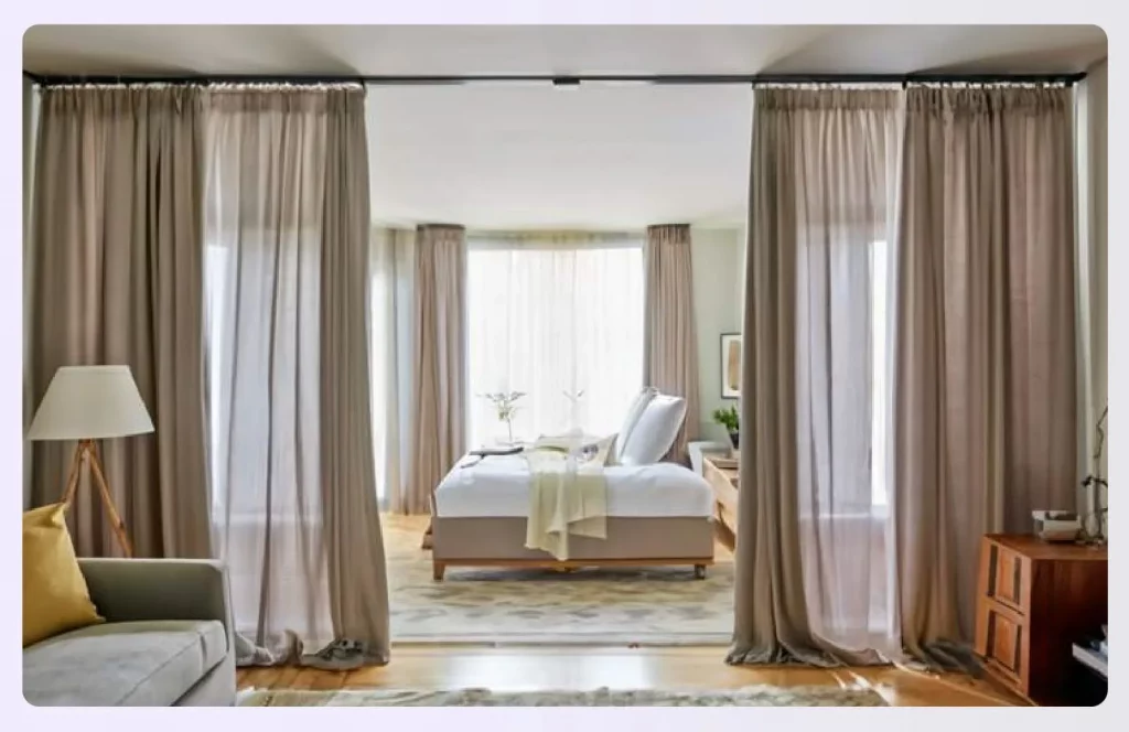 Full-length curtains dividing a living space from a bedroom